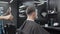 Barber holding a mirror for his male client to check out new haircut