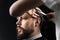 Barber making hairstyle for confident bearded hipster. Advertising for barbershop and men& x27;s beauty salon.