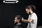 Barber making hairstyle for confident bearded hipster. Advertising for barbershop and men& x27;s beauty salon.