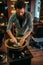 Barber preparing shaving foam in a copper bowl