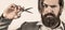 Barber scissors. Bearded man isolated on gray background. Mans haircut in barber shop. Barber scissors, barber shop