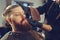 Barber shaves the beard of the client