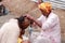 Barber shaves the head of a devotee