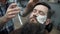 Barber shaves men with a long beard with straight razor blade in s hair salon or barbershop. Man`s haircut and shaving