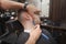 Barber shaving handsome young man