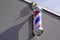 Barber shop light round tricolor pole spiral salon sign in vintage hairdresser on wall with white red blue colors