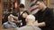 Barber sprays parfume a mature client in barbershop
