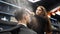 Barber sprays water on client hair before haircut and styling in barbershop. Hairdresser woman wets hair by spray and