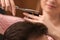 Barber  stylish haircut with professional scissors in beauty salon, closeup