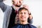 Barber trimming man hair in hair cutter shop