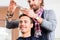 Barber trimming man hair in haircutter shop