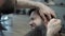 Barber use fire with adult men with a long beard in the men`s hair salon. Grooming the beard. Hairdressers in the