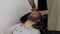 Barber washing hair to bearded man in male salon. Hairdresser wash male head