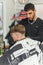 barber works with a male client in the salon, close-up