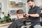 barber works with a male client in the salon, close-up