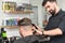 barber works with a male client in the salon, close-up