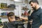 barber works with a male client in the salon, close-up