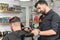 barber works with a male client in the salon, close-up