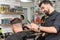 barber works with a male client in the salon, close-up