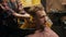 Barbershop: female barber washes the head of male client