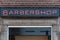 Barbershop neon sign on a brick wall