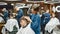 Barbershop services. Side view of professional barber girl serving client, drying hair of a young man sitting in