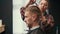 Barbershop: a woman barber cuts a client\'s man\'s hair