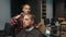 Barbershop: a woman barber cuts a client\'s man\'s hair