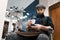 Barbershop worker drinks coffee during a break.