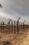 Barbwire secure border of the prison. Fence with metal barb construction