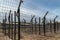 Barbwire secure border of the prison. Fence with metal barb construction