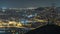 Barcelona and Badalona skyline with roofs of houses and sea on the horizon night timelapse