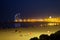 Barcelona - coastline with beach during evening and night, people on promenade, lights and hotels