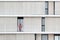 BARCELONA - JUNE 28: Lonely woman standing on a balcony of a modern building facade, on June 28, 2018 in Barcelona