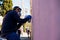 Barcelona, Spain - 30 june 2018: young graffiti artist paiting wall with pink color with daylight in sunny day