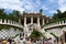 BARCELONA, SPAIN - AUG 30th, 2017: Entrance at the Park Guell designed by Antoni Gaudi with tourists at the stairs