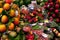 Barcelona, Spain - August 1, 2018: La Boqueria market, Stall of peach, mango and plastic boxes of berries marketplace.
