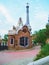 Barcelona, Spain - august 2019: colourful house with tower, pavement and green plants, medium view. Park Guell in