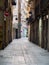 Barcelona, Spain - august 2019: long narrow street between old buildings, long view. Empty pavement between buildings