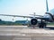 Barcelona, Spain - august 2019: middle distance view on airplanes standing on asphalt takeoff runway. Line of green