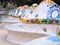 Barcelona, Spain - august 2019: pattern of multicolour mosaic on seats, medium view. Benches in park. Park Guell in