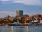 Barcelona, Spain - august 2019: several white boats moored to wharf, long view. Houses and modern building on sea. Blue