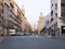 Barcelona, Spain - august 2019: wide road in city center, long view. Road traffic and cars parked near building. Modern