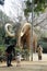 Barcelona, Spain, January 2017. A father with a child interested in a huge mammoth layout in a city park.