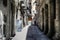 Barcelona, Spain - July 3, 2016: Person walking down a lane in the Gothic Quarter of Barcelona