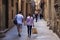 BARCELONA, SPAIN - MAY 15, 2017: Unknown young coiple walking in the Carrer de Montcada street in historical Gothic quarter of