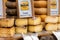 Barcelona, Spain - May 15, 2020. Street market stall with MahÃ³n cheese, made with cow\'s milk. Uncooked pressed paste