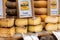 Barcelona, Spain - May 15, 2020. Street market stall with MahÃ³n cheese, made with cow's milk. Uncooked pressed paste, with