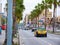 Barcelona, Spain. May 2019. Passeig de Colom, a wide avenue lined with palm trees, with a red bridge over the road viewing