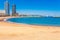 Barceloneta beach in Barcelona. Nice sand beach with palms. Sunny bright day with blue sky. Famous tourist destination in